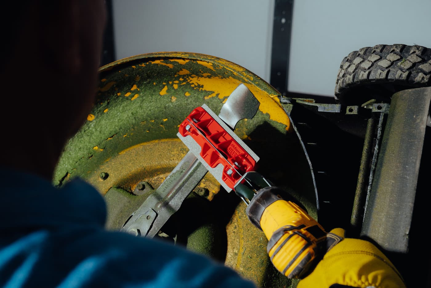 Close-up of a mower blade being sharpened with the 60 Seconds Sharp tool on a reciprocating saw